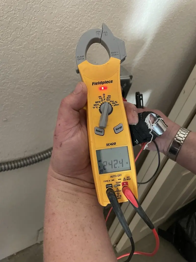 Voltage testing with clamp meter during Ceiling Fan Installation in Blythe